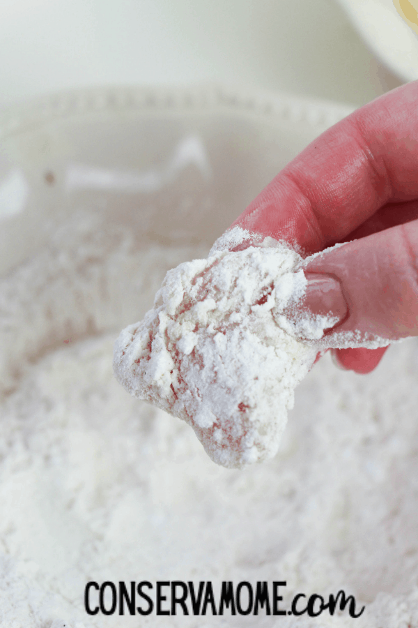 dredging the chicken in flour mixture