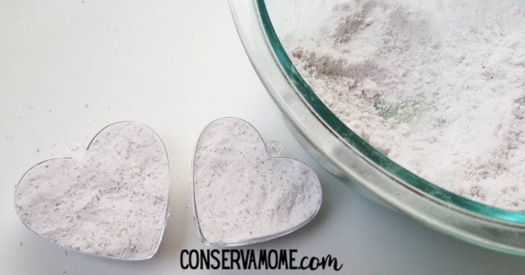 firmly packing each side of the bath bomb heart mold