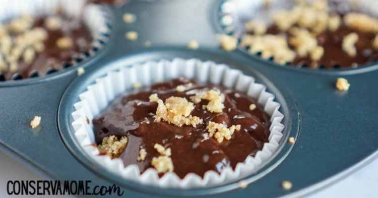 adding in the brownie batter and topping with graham cracker crumbs