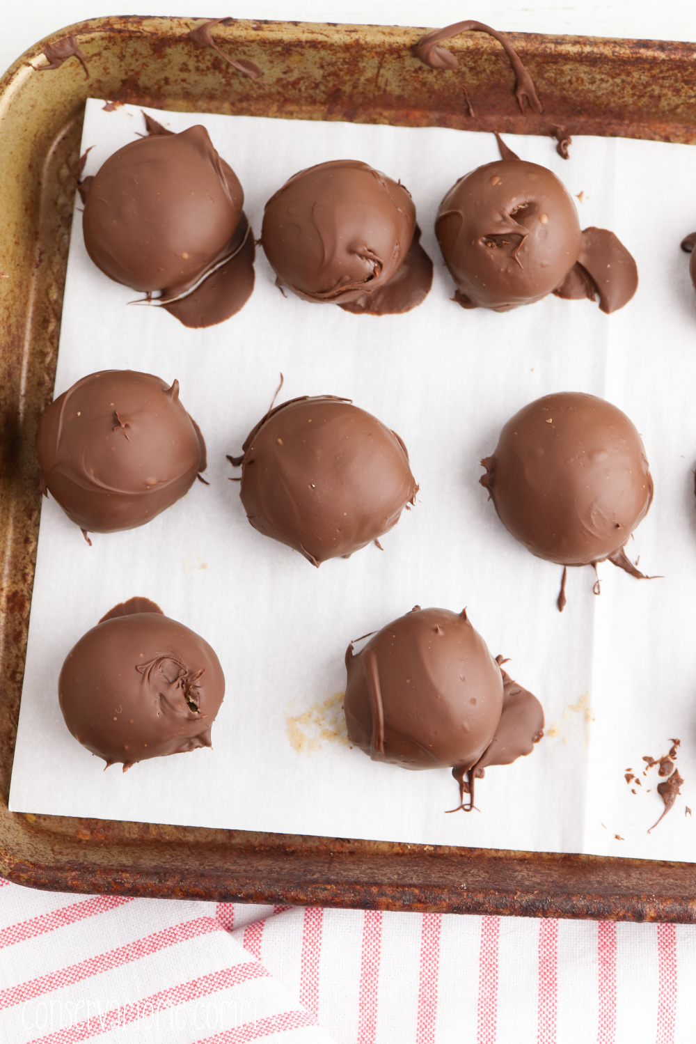covering the cookie dough balls with chocolate 