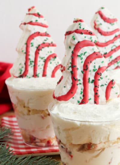 Do you love Christmas Tree Cakes then Check out Christmas Tree Cakes Cheesecake Cups the perfect Holiday Dessert idea!