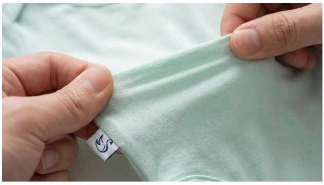 Close-up of a baby's soft skin against premium bamboo fabric.